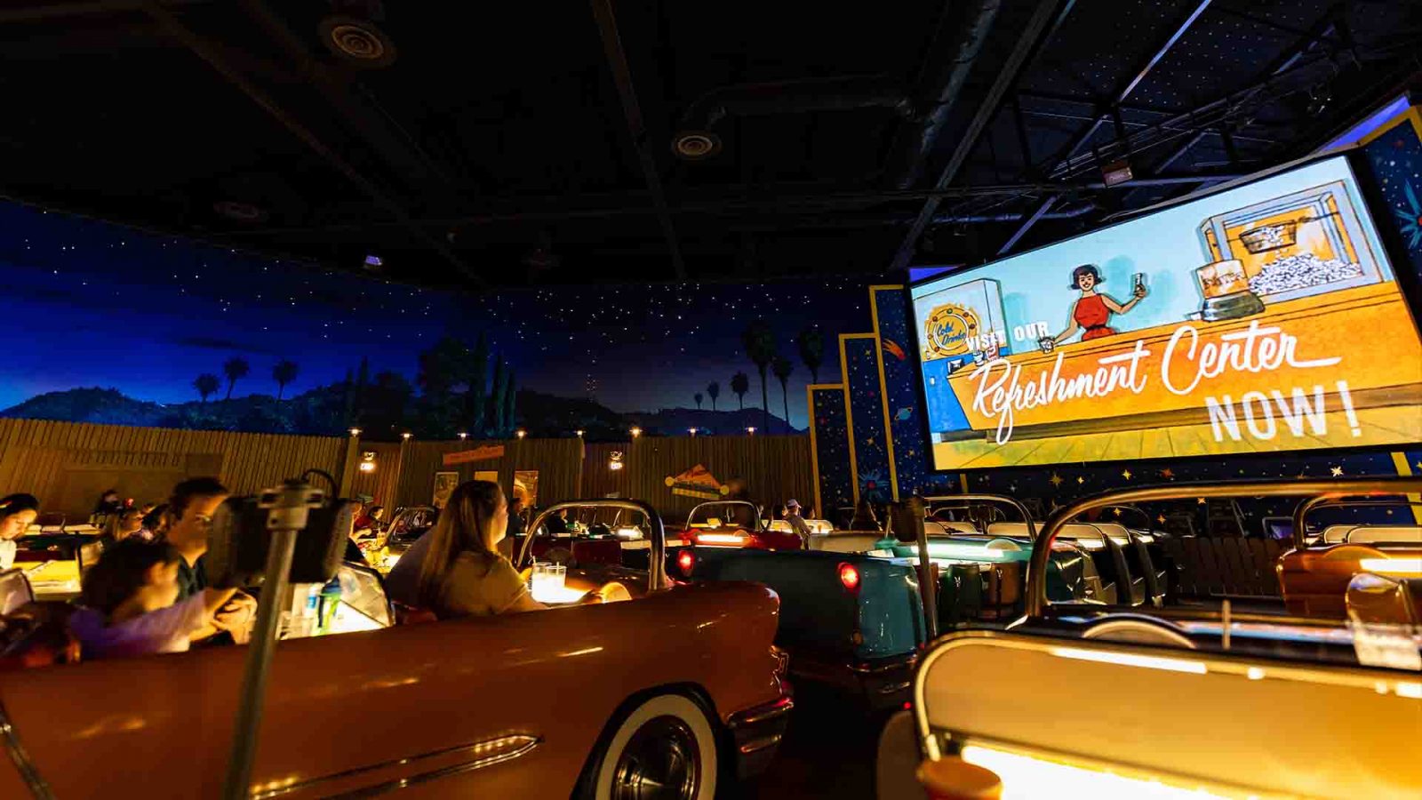 Sci-Fi Dine-In Theater interior photo of automo-booths and movie screen.