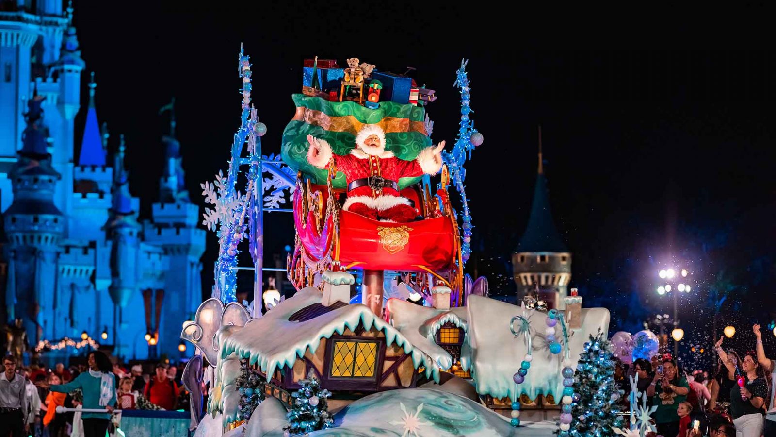 Santa Clause on his sleigh float in Mickey's Once Upon A Christmastime Parade in front of Cinderella Castle